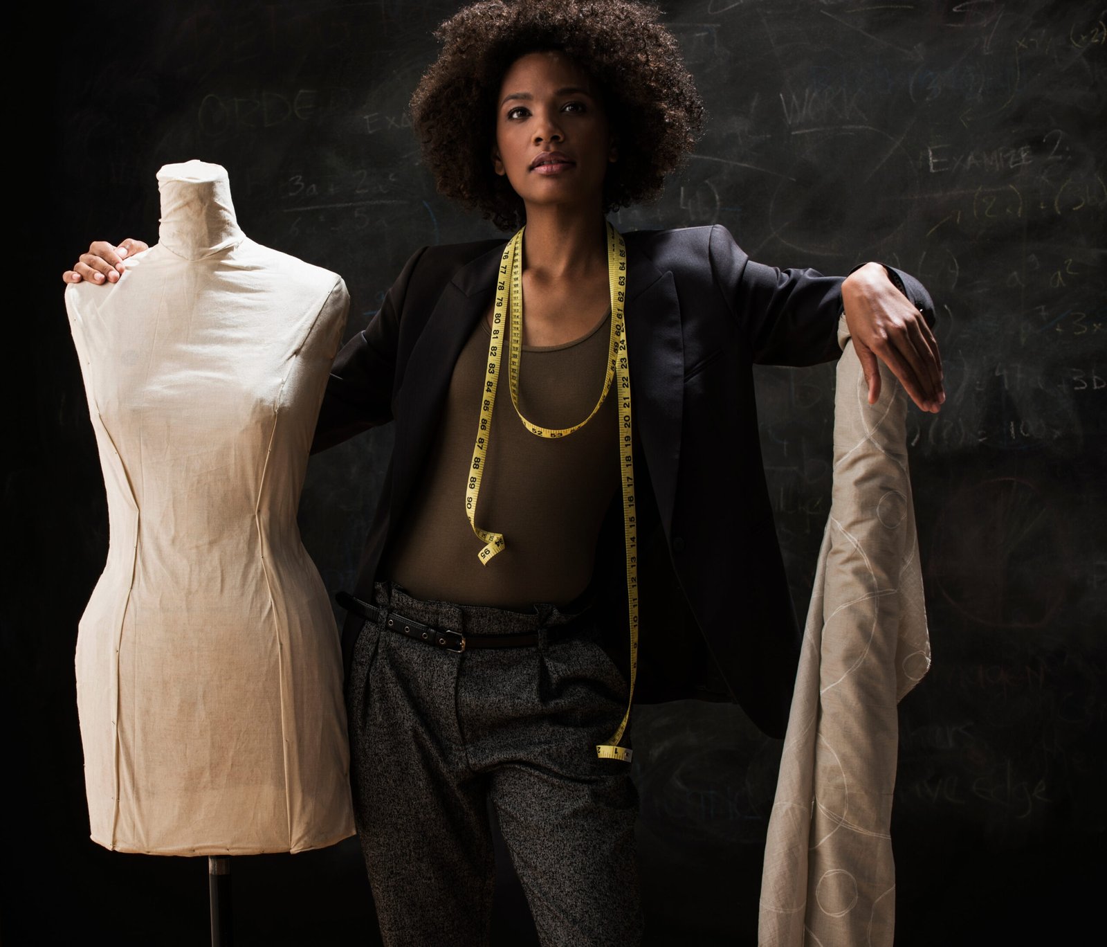 Businesswoman with tailors dummy and fabric